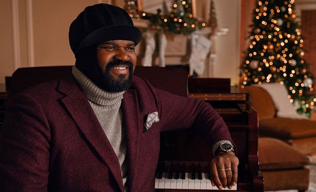 Gregory Porter is sitting on a sofa